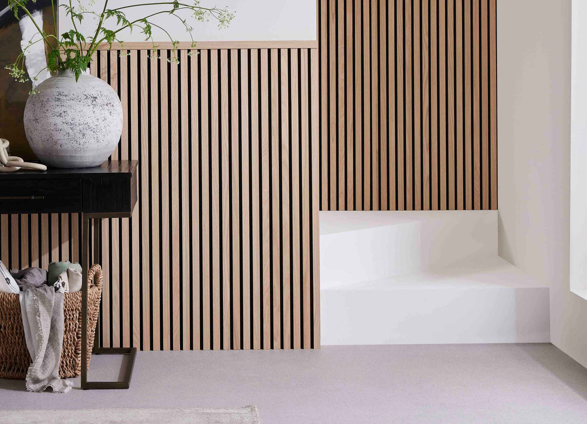 Stairs and hall featuring SlatWall Midi Natural Oak panelling, a black table, brown storage basket and grey vase.