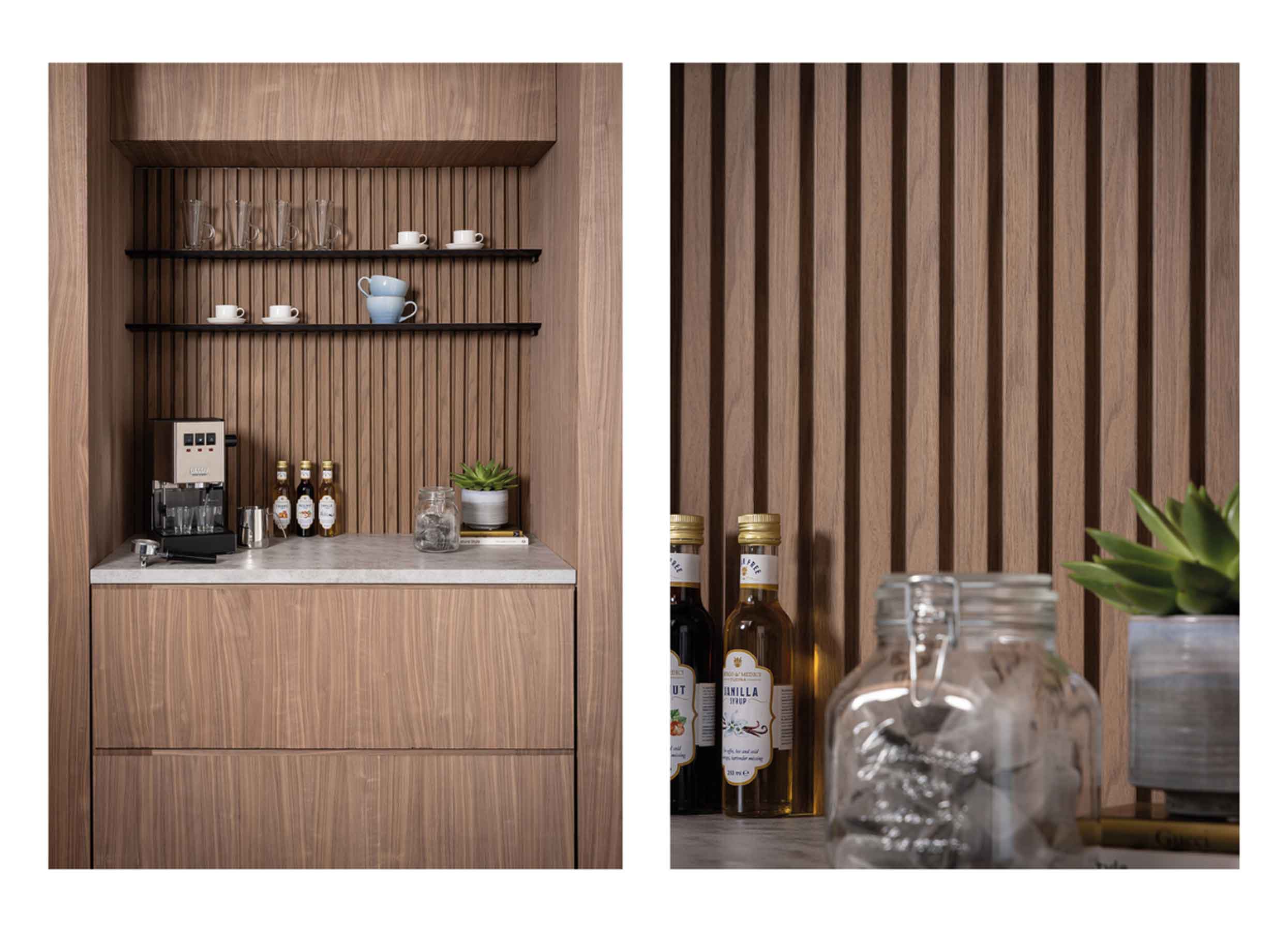 Brown wall panelling behind a coffee machine and shelves with cups, mugs, a jar of tea bags and syrup bottles in a kitchen.