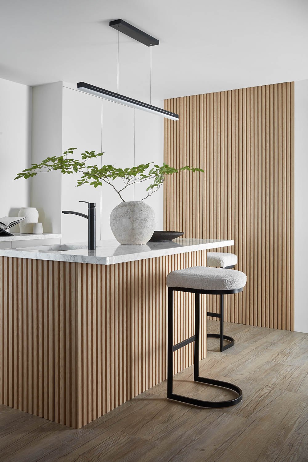 Natural Oak SlatWall Waterproof on kitchen wall and around the base of a breakfast bar.